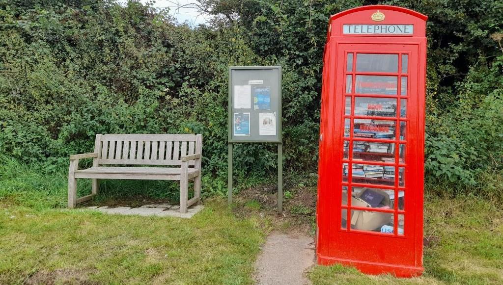 bench, noticeboard and book exchange in Thurloxton